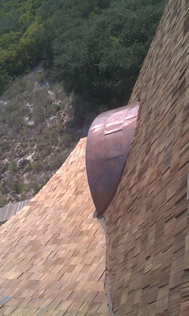close up of a metal vent extruding from a roof